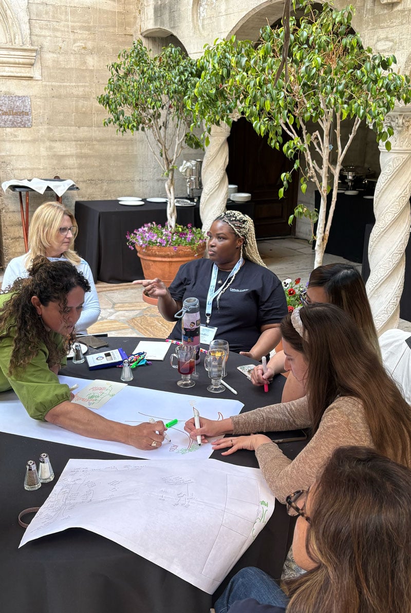 LFM Academy participants working in groups.