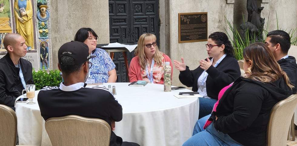 A group of LFM alumni in discussion.